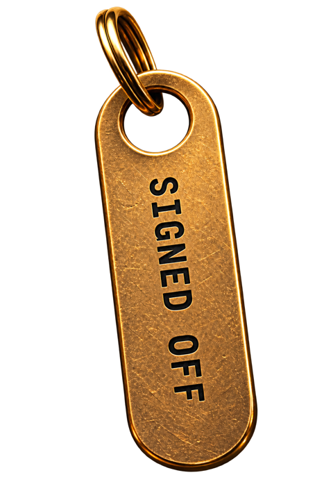 A brass key tag engraved SIGNED OFF.